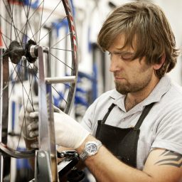 A man works on a bicycle wheel