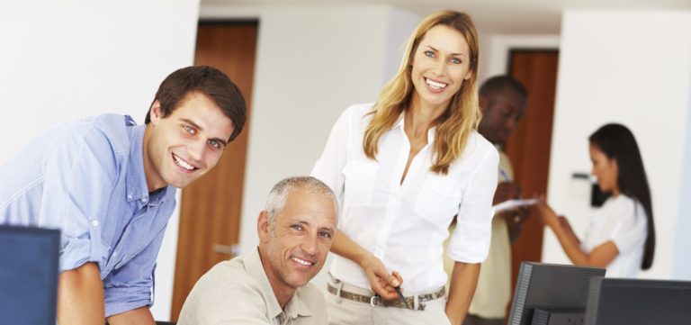 Group of smiling people who are working in an office environment